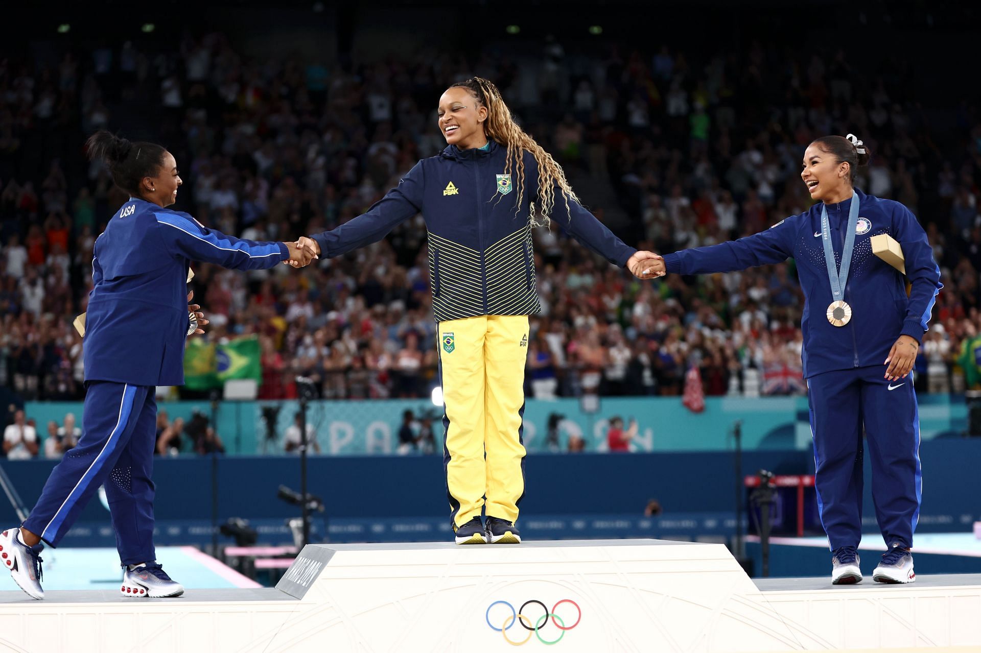Rebeca Andrade, Simone Biles, and Jordan Chiles sharing the podium in the women’s floor exercise at Olympic Games 2024 - Source: Getty